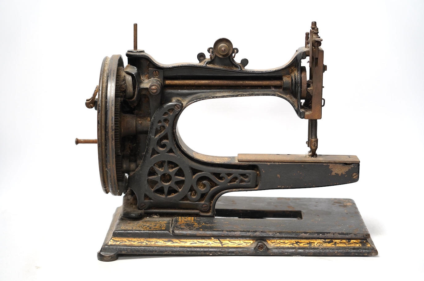 An 1870's Edward Ward sewing machine and a cast iron base with gilt decoration and maker’s marks. Condition - fair